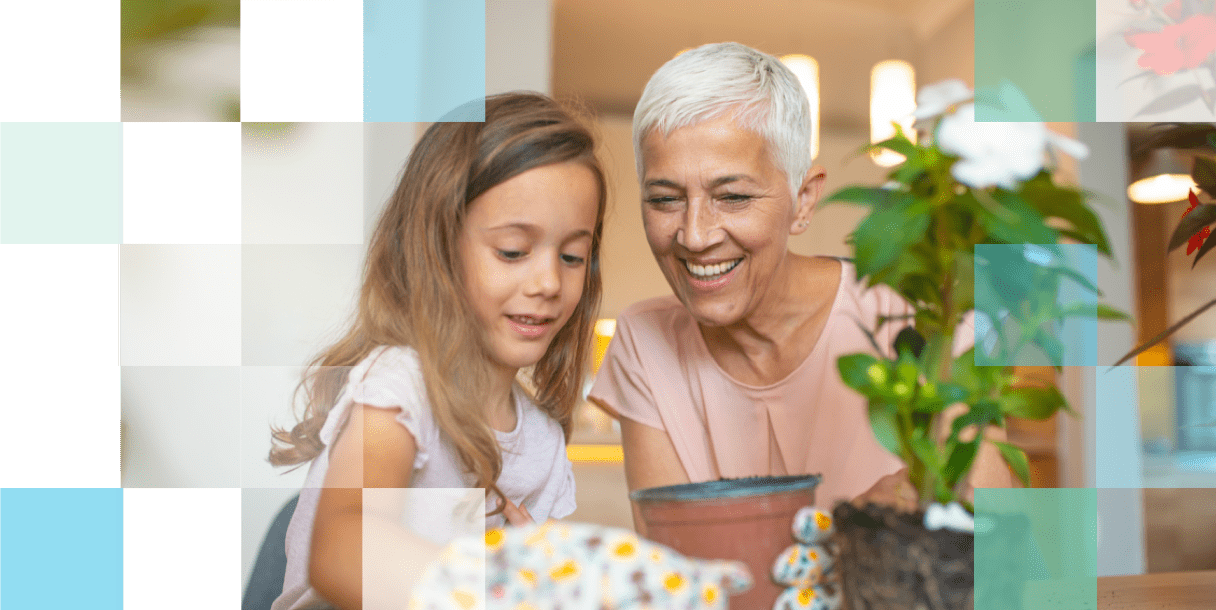 Grandparent and grandchild re-potting a plant after finding the right eye care product for their vision needs