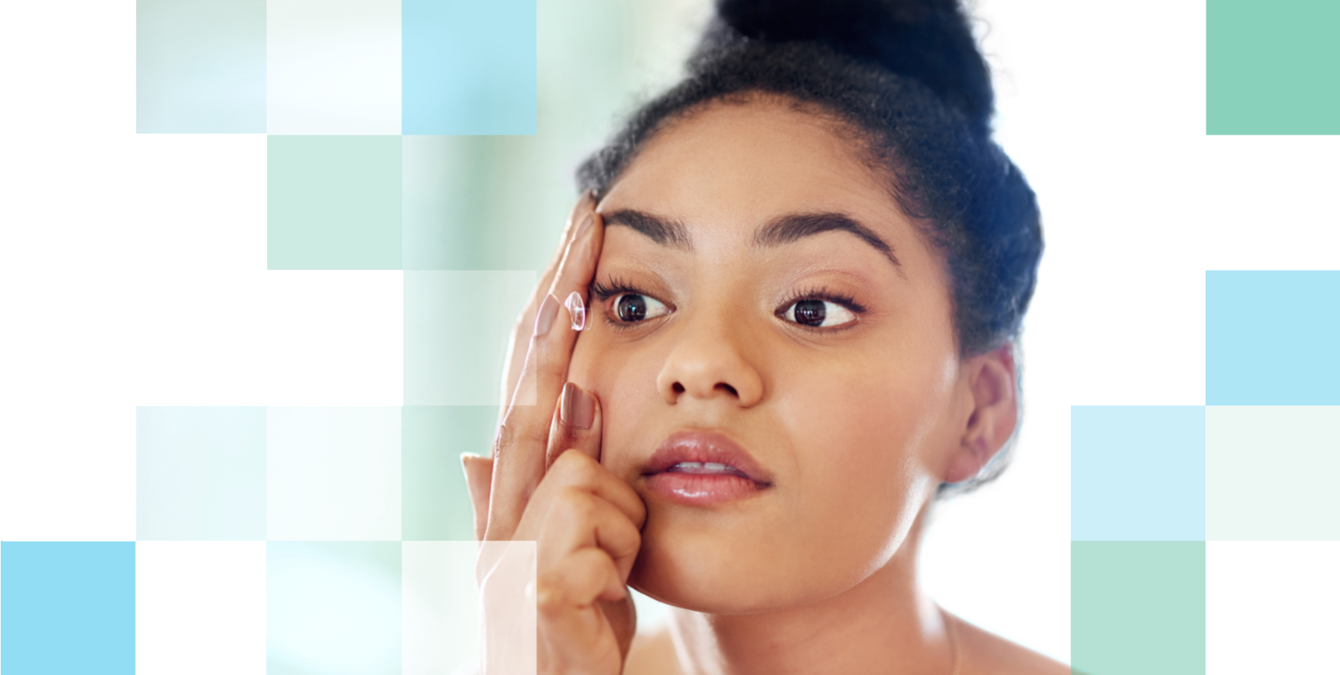 Woman inserting a contact lens into her right eye