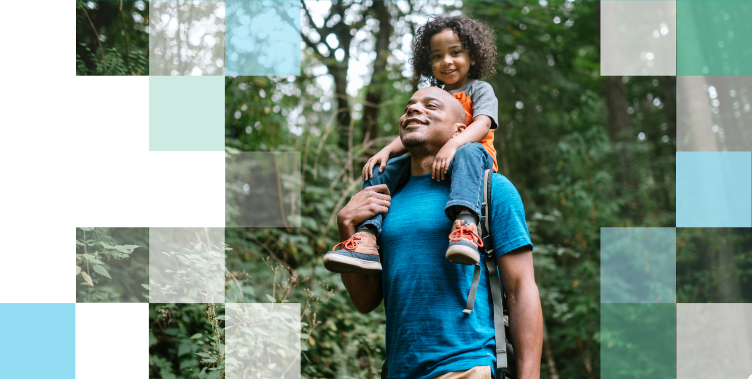 Parent and child walking through lush green forest on a hike