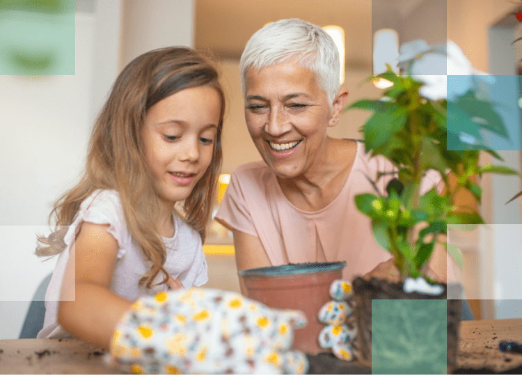 Grandparent and grandchild re-potting a plant after finding the right eye care product for their vision needs