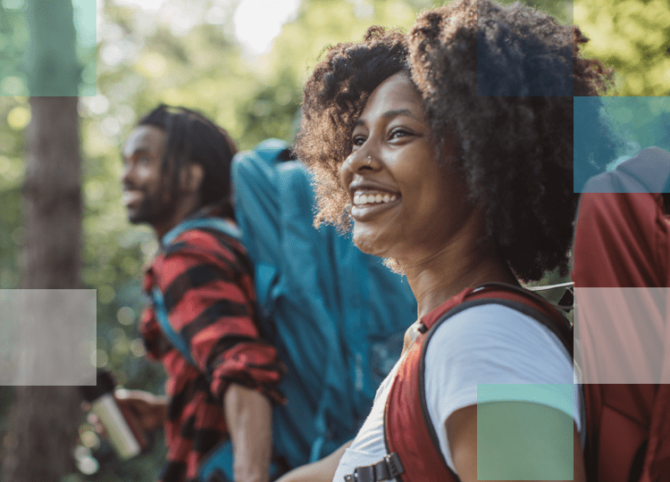 Couple going for a hike with backpacks on smiling