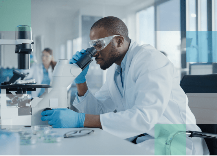 Eye Care Professional in laboratory looking through a microscope at a sample