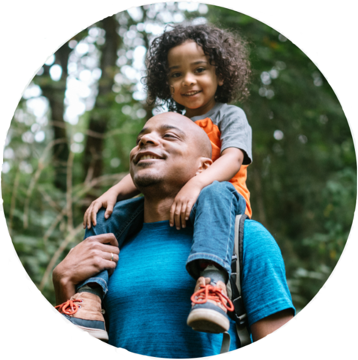 Parent and child going for a hike in a lush green forest